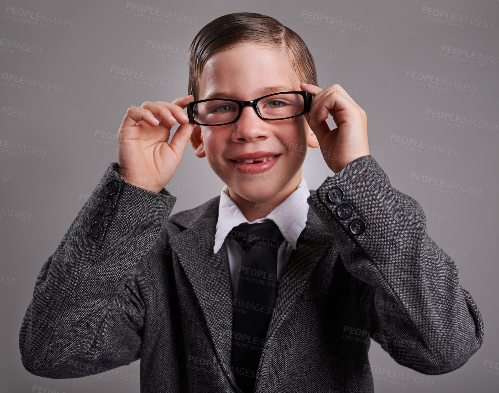 Buy stock photo Portrait, costume and boy with glasses, business and Halloween dress up on a grey studio background, Face, person and model with vision and eyewear with child development and smile with retro clothes