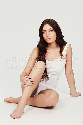 Buy stock photo Full-length portrait of a beautiful young woman sitting in the studio