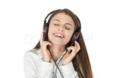 Buy stock photo Studio shot of a woman listening to music through headphones