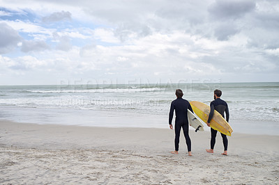 Buy stock photo Two young surfers on the beach