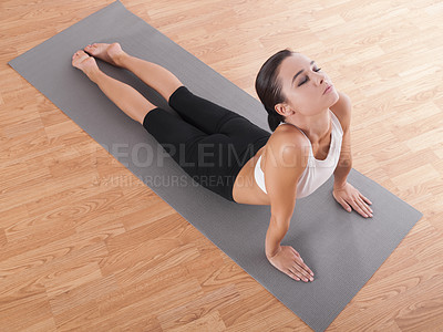 Buy stock photo Woman, yoga and stretching on mat for workout, training or exercise on wooden floor above at gym. Top view of calm female person or yogi in cobra pose, fitness or health and wellness for pilates