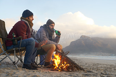 Buy stock photo Campfire, friends and beer with men by the beach at sunset with vacation and camping. Ocean, outdoor and together with travel and people in a trip and journey with fire and alcohol by sea at dawn