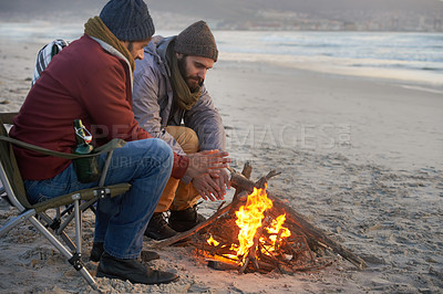 Buy stock photo Campfire, friends and adventure with men by the beach at sunset with vacation and camping. Ocean, outdoor and together with travel and people in a trip and journey with fire and conversation by sea