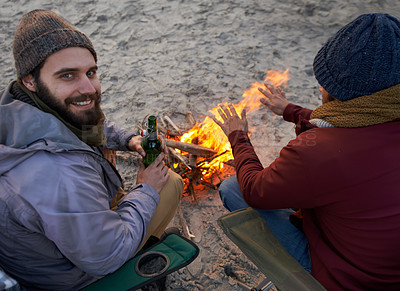 Buy stock photo Campfire, friends and portrait with men and beer by the beach at sunset with vacation and camping. Ocean, outdoor and together with travel and people with journey and fire with conversation by sea