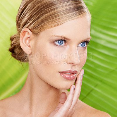 Buy stock photo Woman, thinking and skincare with leaf for beauty, detox and organic hydration benefits. Female person, makeup and hand on face with confidence for wellness, glow and daily facial routine in closeup