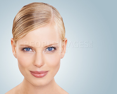 Buy stock photo Portrait, skincare and woman with cosmetics, wellness and beauty on a blue studio background. Face, person or model with shine and makeup with grooming or dermatology with aesthetic, mockup or facial