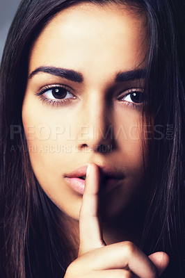 Buy stock photo Woman, finger and quiet for mystery in studio portrait, secret and confidential information or emoji. Female person, private and shush icon on gray background, closeup and silence for announcement