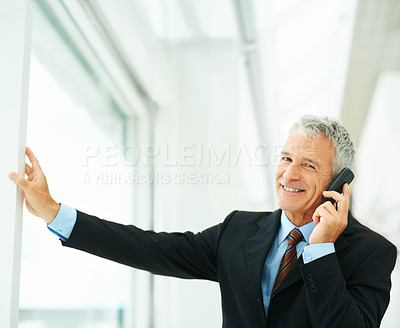 Buy stock photo Mature employee, smile and phone call in office building talking to boss of corporate company for business. Executive, chat and happy for job in workplace, technology and connect for communication