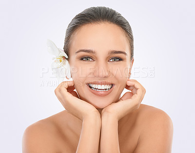 Buy stock photo Girl, portrait and orchid with glow for skincare in studio, beauty and natural makeup for blossom. Woman, plant and white background, closeup and hands on face with cosmetics dermatology for wellness