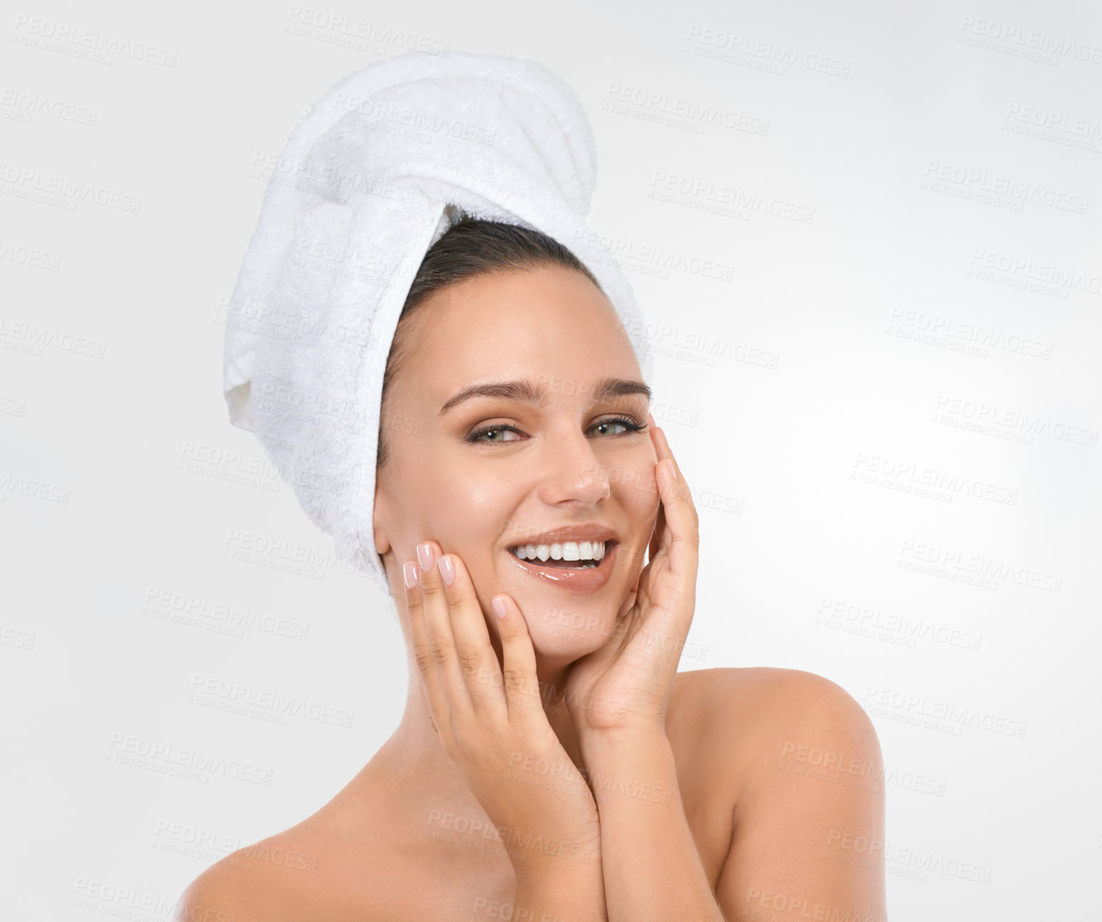 Buy stock photo Studio shot of an attractive brunette model with her hair wrapped in a towel