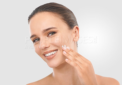 Buy stock photo Woman, skincare and facial cream in studio for beauty, dermatology or collagen treatment. Happy, female person and product in portrait for wellness, moisturizer and cosmetics on white background