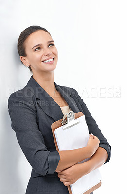 Buy stock photo Studio shot of an attractive young businesswoman looking thoughtful isolated on white