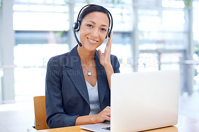 Buy stock photo An ethnic tele-marketer taking making a call to a client