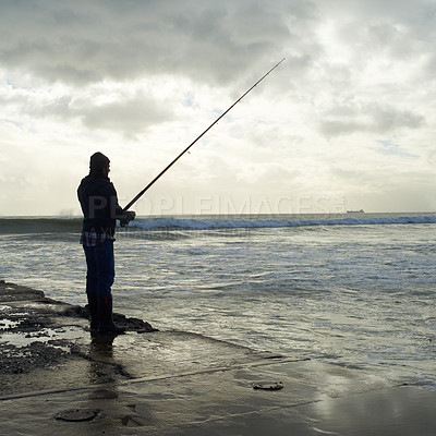 Buy stock photo Casting, fishing rod and man at a beach for water hobby, recreation or stress relief in nature. Pole, line and male fisherman at the ocean for travel, journey or fish sports adventure in Cape Town