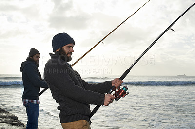 Buy stock photo People, sea and friends with fishing rod at beach, relax and casting a line by ocean waves. Men, fisherman and cloudy sky on vacation or holiday, hobby and bonding by water and support on adventure