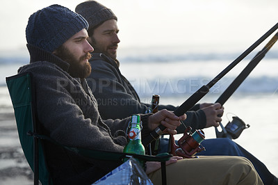 Buy stock photo Friends, men and fishing on beach in nature with rod, alcohol and relax on vacation, holiday or travel. Friendship, people and bonding in morning with overcast, sky and waves for activity or hobby