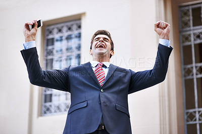 Buy stock photo Celebration, phone and excited businessman with winner fist in a city for competition, prize or giveaway. Smartphone, success and male lawyer with wow news, email or notification outdoor with victory
