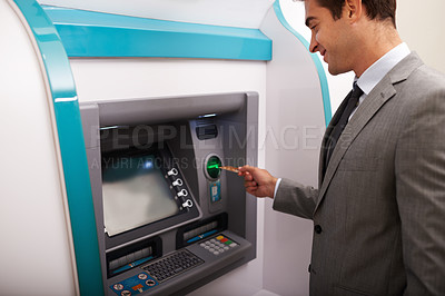 Buy stock photo Shot of a businessman making a cash withdrawal at an ATM