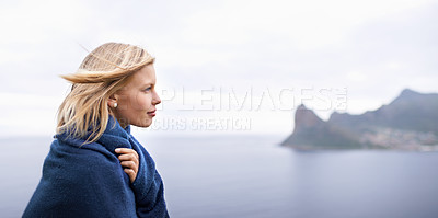 Buy stock photo Thinking, ocean and woman with blanket in nature for adventure on holiday, vacation and weekend outdoors. Mountain, travel and person by seaside for relaxing, happiness and peace in countryside