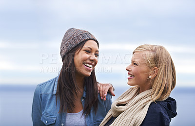 Buy stock photo Friends, happy and women by ocean laugh for adventure on holiday, vacation and weekend outdoors. Nature, travel and people talking by seaside for fun, relaxing and bonding together in countryside