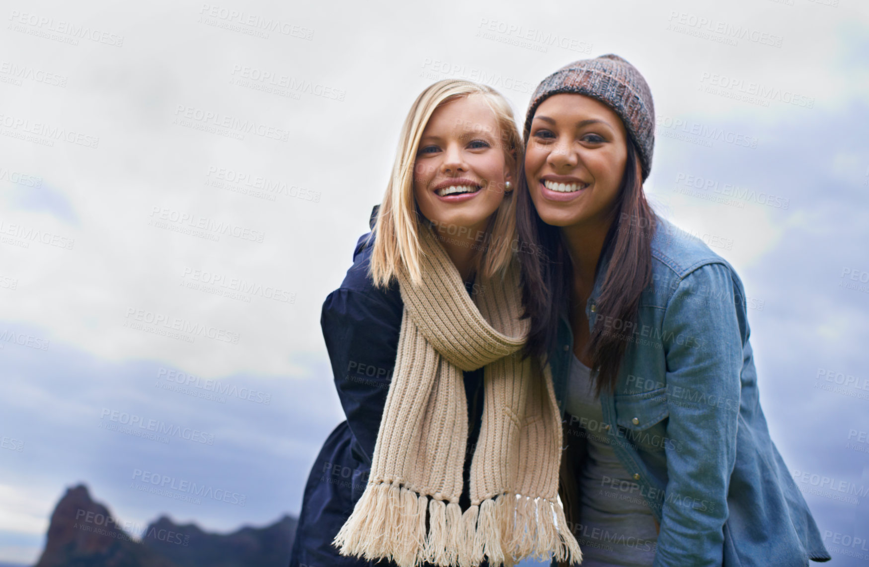 Buy stock photo Two young women laughing outside