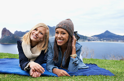 Buy stock photo Two young women laughing outside