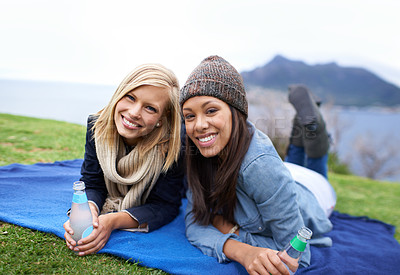Buy stock photo Picnic, grass and portrait of women in field with smile, happy and relaxing on weekend outdoors. Friends, countryside and people with drinks for bonding on holiday, vacation and adventure in nature