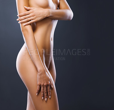 Buy stock photo Cropped studio shot of a gorgeous woman posing in the nude against a gray background