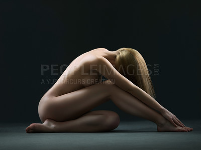 Buy stock photo Side view of a beautiful naked woman posing in studio