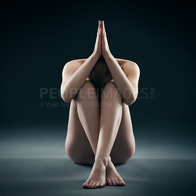 Buy stock photo Shot of a nude woman sitting with her legs crossed and her arm