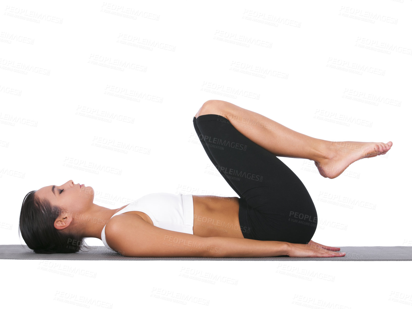 Buy stock photo A young woman doing stretches while isolated on white