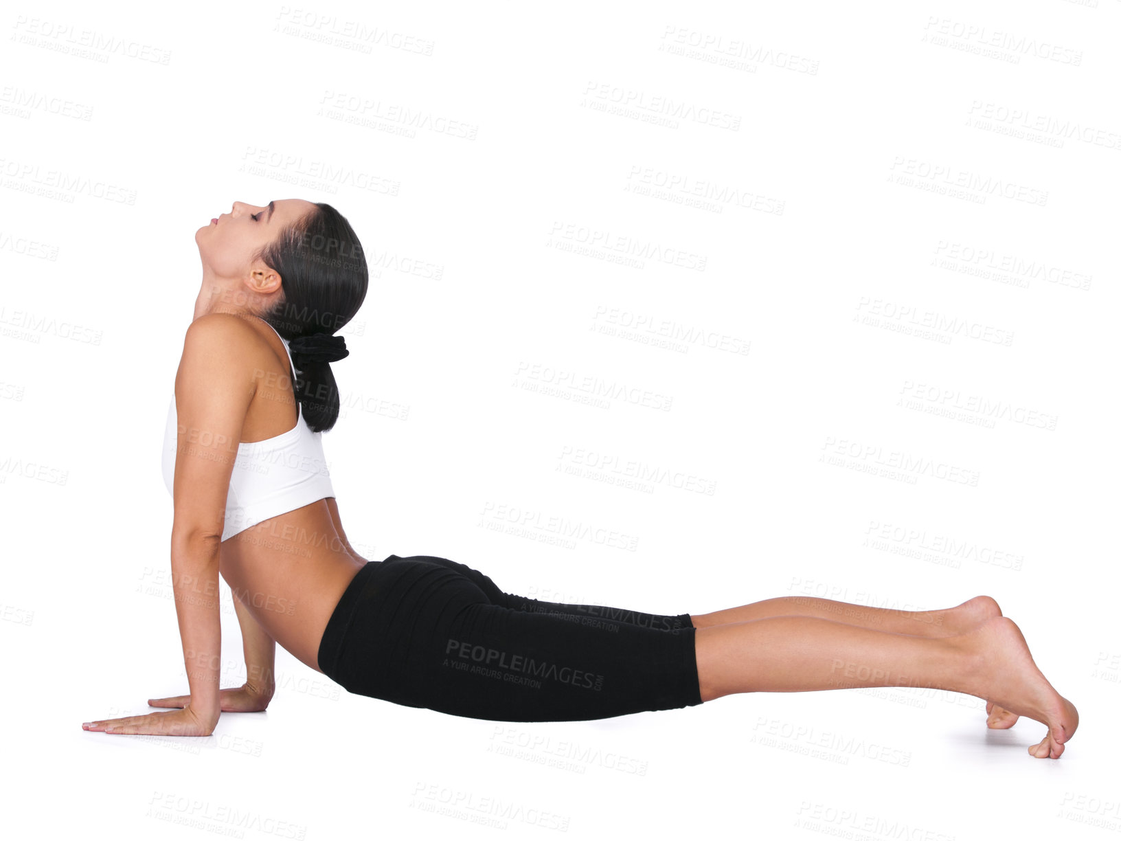 Buy stock photo A young woman doing yoga stretches while isolated on white