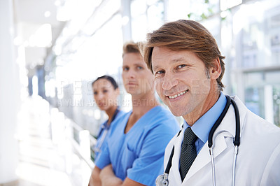 Buy stock photo Teamwork, doctors and portrait of man in hospital for medical service, insurance and support. Healthcare, clinic and face of happy men and women in hallway for collaboration, consulting and medicine
