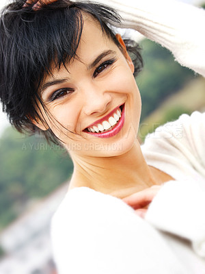 Buy stock photo Closeup portrait of a beautiful young woman smiling at the camera