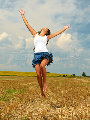 Buy stock photo Shot of a beautiful young woman in the countryside with her arms outstretched in joy