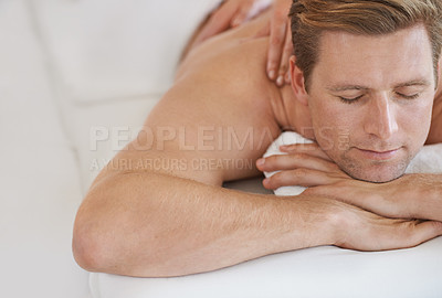 Buy stock photo Hands, back massage and man at spa to relax, peace and calm at luxury resort for wellness. Service, therapy or person at salon to pamper body, skincare or beauty treatment for health with eyes closed