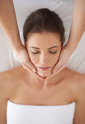 Buy stock photo Shot of a young woman receiving a face massage