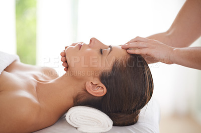 Buy stock photo Spa, massage and hands on head of woman to relax on table for skin care, treatment or facial. Calm, person and girl in salon or resort on holiday or vacation with wellness and healthy stress relief