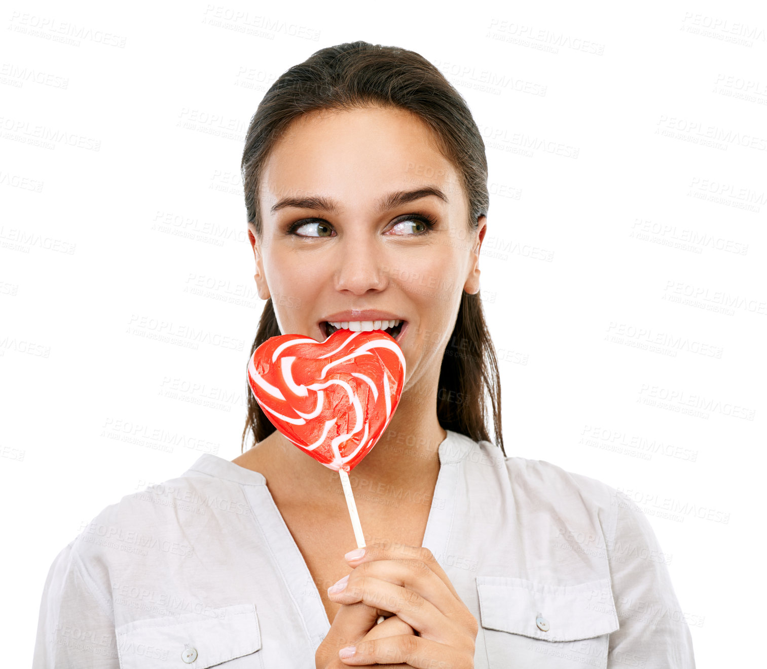 Buy stock photo Happy, candy and woman with a lollipop in a studio for a sweets craving, dessert or sugar. Happiness, snack and young female model eating a heart shape sweet while isolated by a white background.