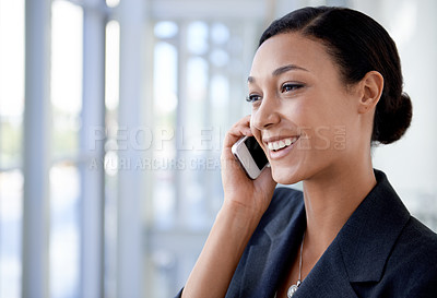 Buy stock photo An ethnic businesswoman talking on a cellphone