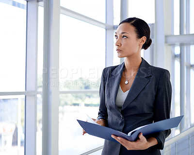 Buy stock photo A businesswoman holding an opened file