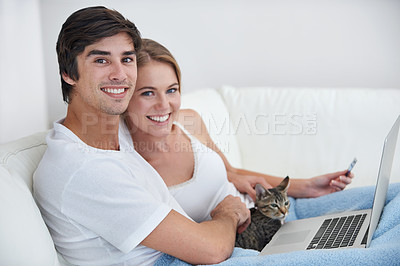 Buy stock photo Couple, living room and cat with laptop, sofa and credit card for online shopping, relaxation or date. People, computer and pet with portrait, home and kitten with love and smile for happiness