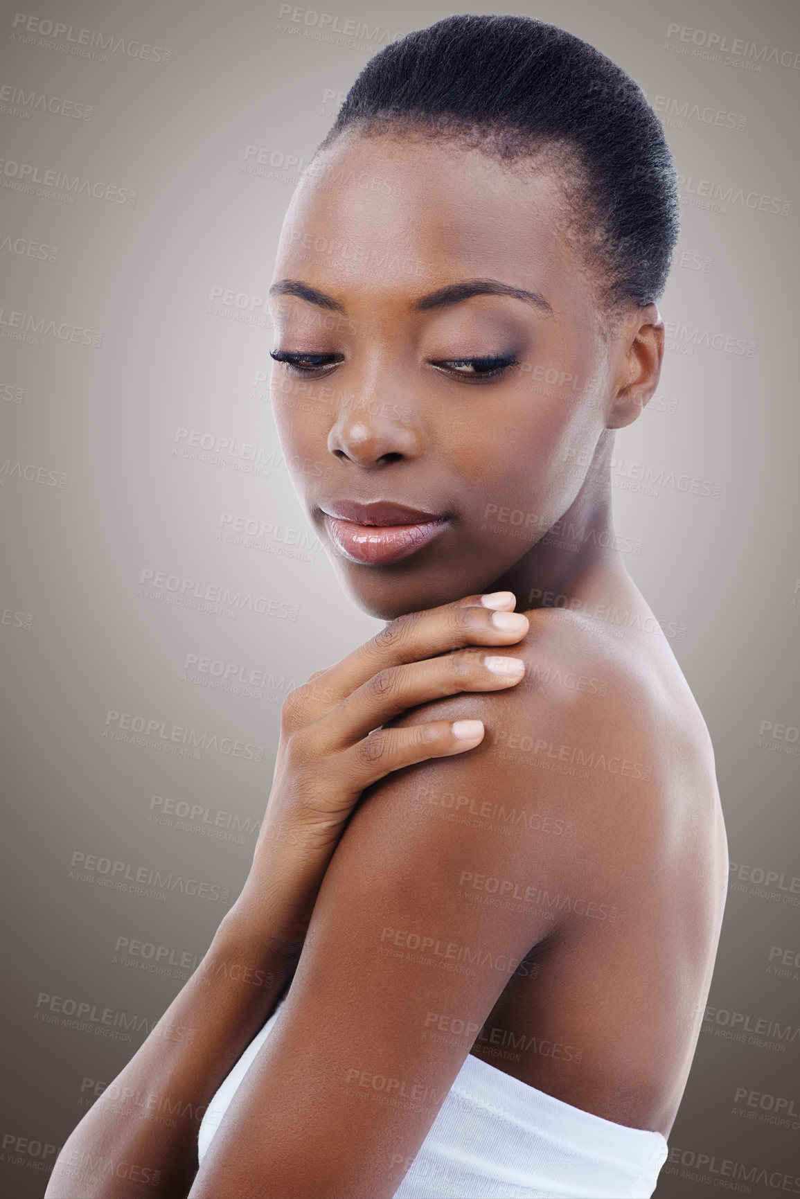 Buy stock photo Skincare, touch and face of black woman in studio with shoulder, natural makeup and healthy glow. Cosmetics, dermatology and beauty model girl on grey background for skin care, shine or wellness.
