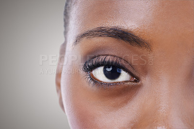 Buy stock photo Half, face and eye of black woman closeup for beauty or dermatology in gray background mockup. Skincare, portrait and African model with natural glow from makeup, cosmetics or facial in studio