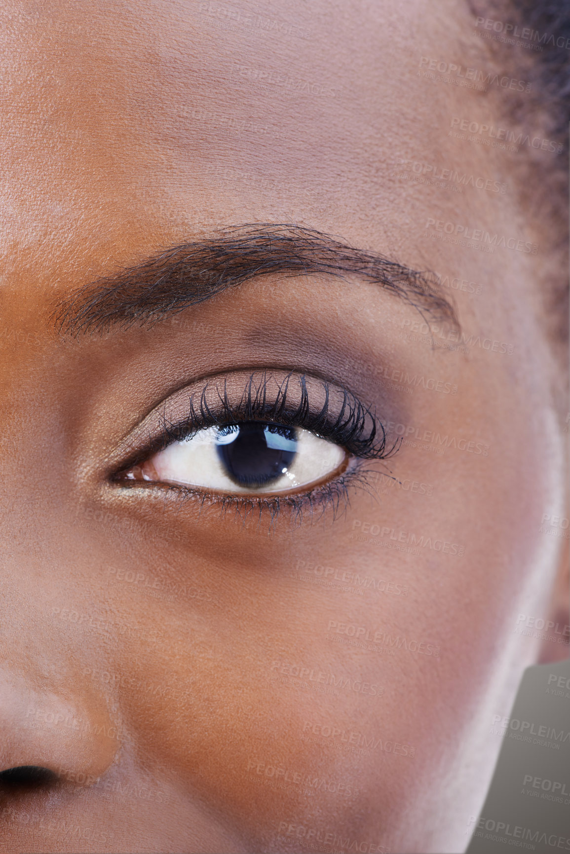 Buy stock photo Eyeshadow, makeup and black woman closeup with beauty and skincare on half of face. Eye, portrait and African model with healthy glow and shine on skin from dermatology, cosmetics or foundation