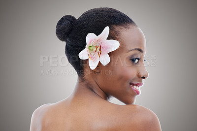 Buy stock photo Flower, skincare and smile of black woman profile in studio on gray background for cosmetic wellness. Aesthetic, beauty or floral dermatology and back of happy young person at spa with orchid plant