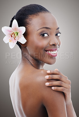 Buy stock photo Skincare, beauty and portrait of black woman with flower on gray background for wellness, cosmetics and makeup. Dermatology, salon and person for aesthetic, natural face products and facial in studio