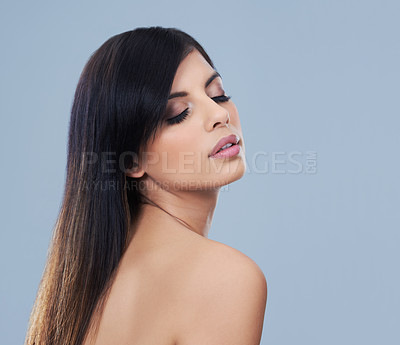 Buy stock photo Health, hair care and woman with cosmetics in studio for beauty, wellness and salon treatment. Confident, makeup and female person with facial and hairstyle routine by blue background with mockup.