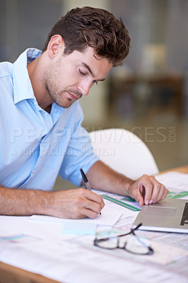 Buy stock photo An attractive male architect focused on his work