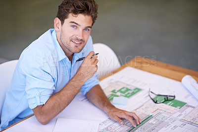 Buy stock photo Shot of a handsome architect working on his plans